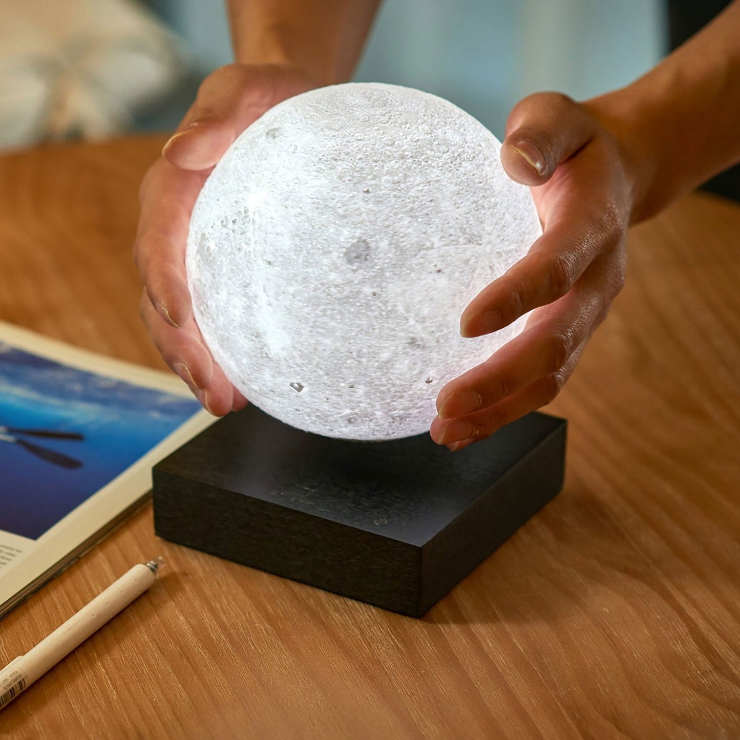 Casora Levitating Moon Lamp - dark mode showing the warm glow